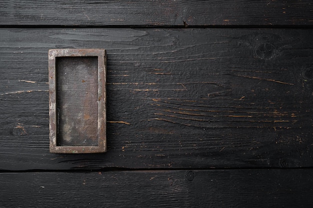 Empty dark wooden box set with copy space for text or food, top view flat lay, on black wooden table background