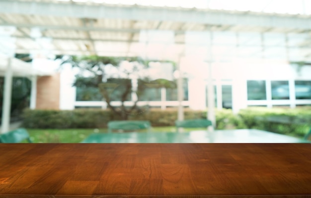 Empty dark wooden table in front of abstract blurred bokeh background of restaurant can be used for display or montage your productsMock up for space