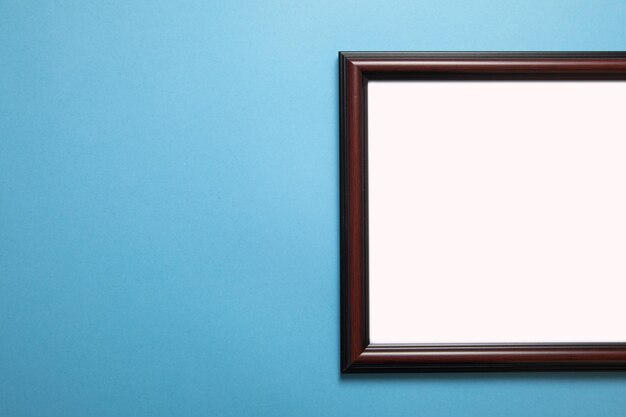 Empty diploma or certificate frame on the blue background