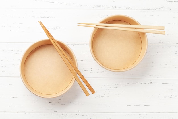 Empty disposable poke bowls and chopsticks