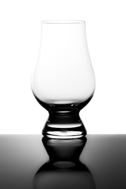 Empty Dram Whisky Tasting Glass and Reflection Isolated on White