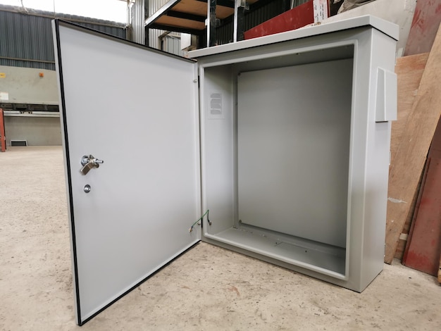 Empty electrical metal cabinet on the concrete floor.