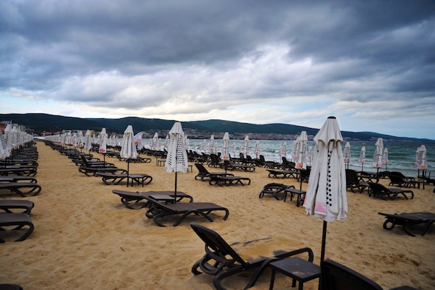 empty empty beach with folded beach umbrellas