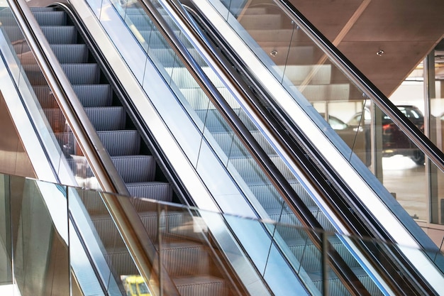 Empty escalator inside a glass building