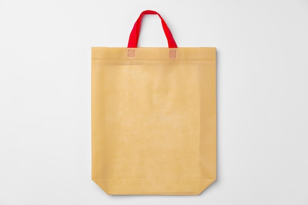 Empty fabric shopping bag on white background