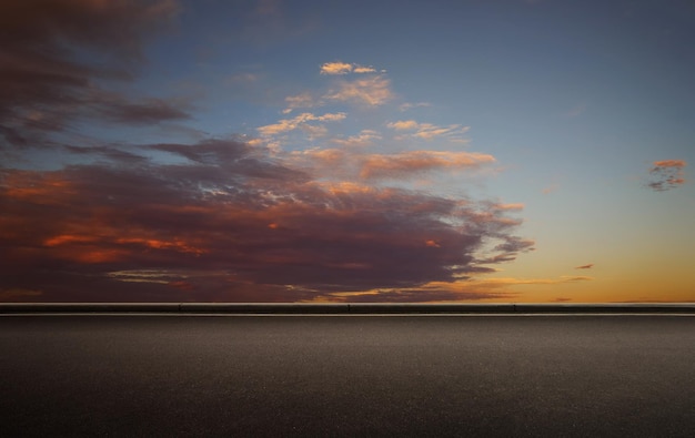 Empty floor with beautiful colorful clouds early morning sky