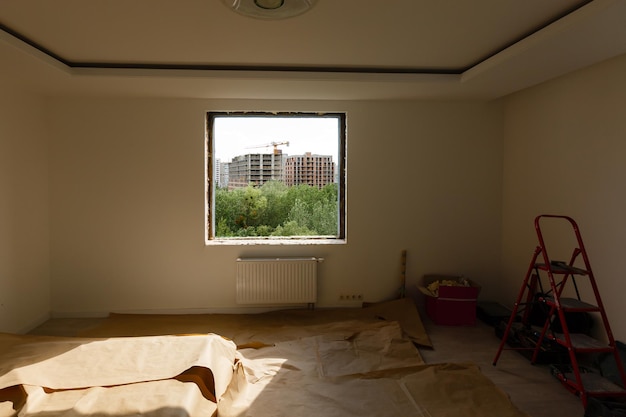 Empty frame on a wide panoramic window. gorgeous view from the\
window of an apartment in a multi-storey building. roofs of houses\
and trees from a height. beautiful view through the window. frame\
for