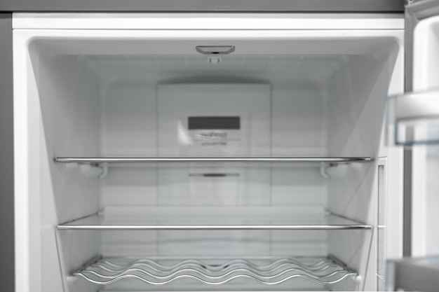 Empty fridge background inside view into refrigerator with glassy shelfs food storage concept empty shelves for products New clean refrigerator Open empty fridge inside interior