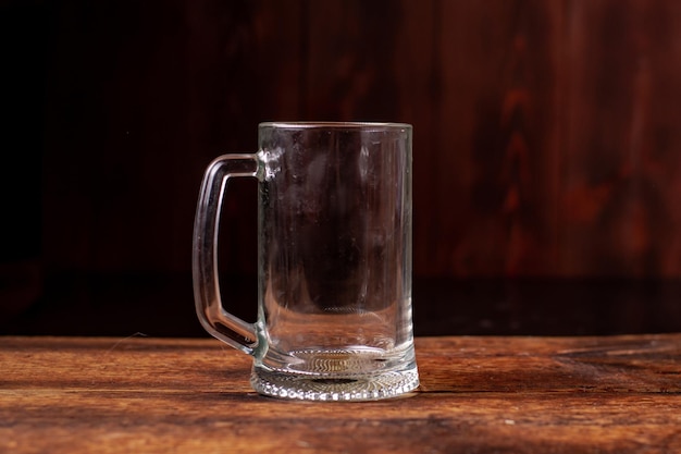 Empty glass for beer on a wooden background Dirty beer glass