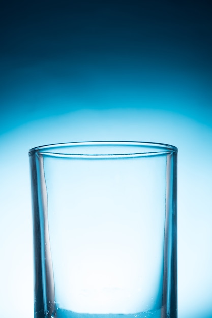 Empty glass on a blue background.