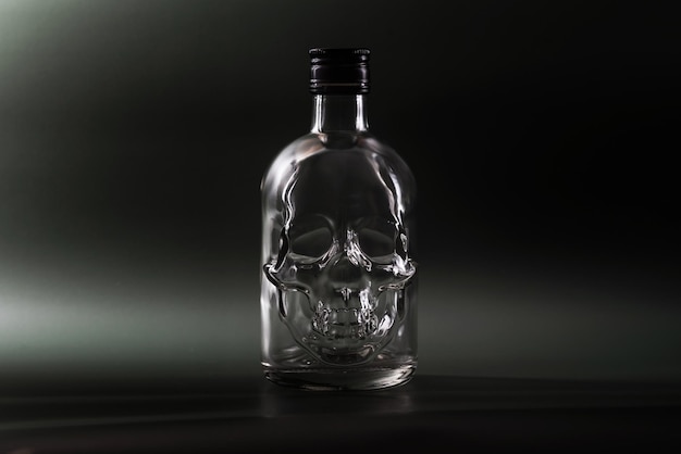 empty glass bottle in the shape of a human skull