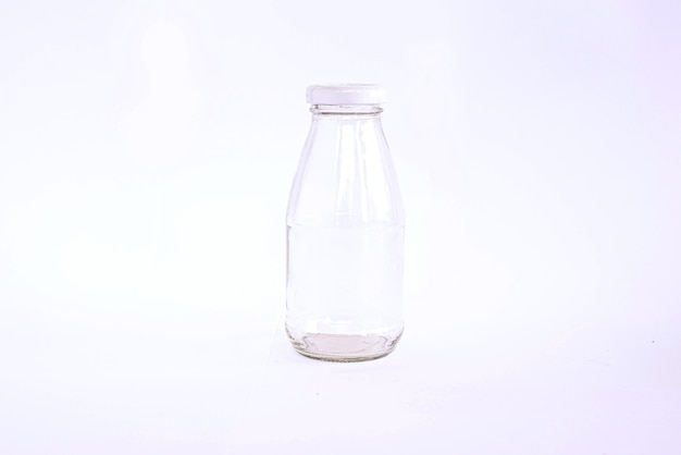 Empty glass bottle on white