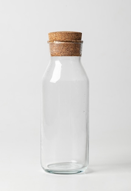 Empty glass jar with brown corke isolated on white background