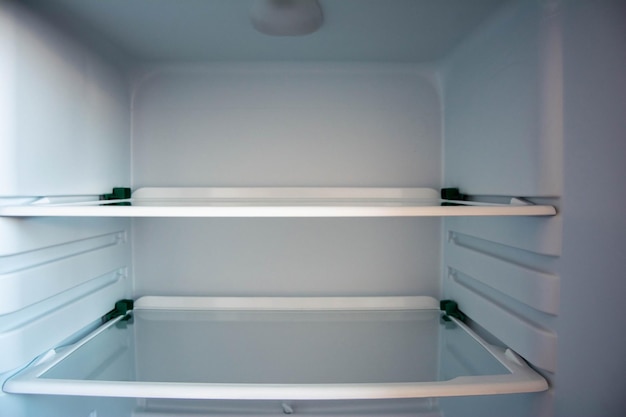 Photo empty glass shelves of the new refrigerator interior organizer