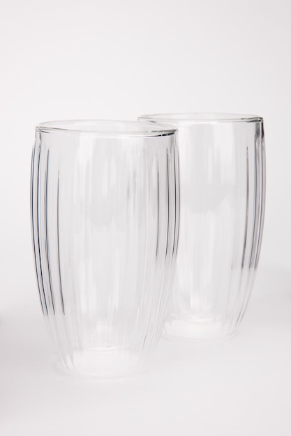 Empty glass tea mug closeup on white background