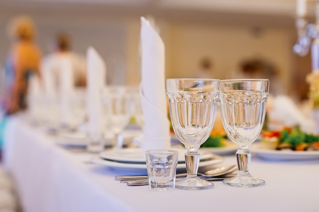 Empty glasses and dishes set in luxury restaurant