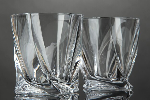 Empty glasses on gray background