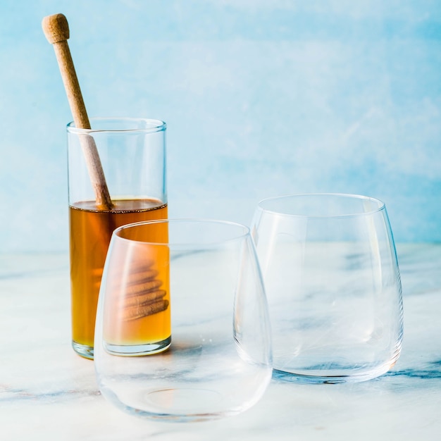 Empty glasses and honey on a table