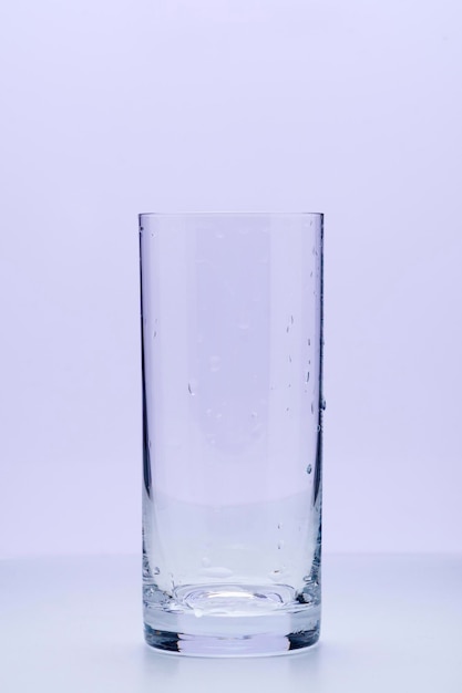 Empty glasses on a light lilac background