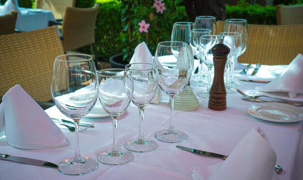 Empty glasses set in restaurant. Served table at summer terrace cafe