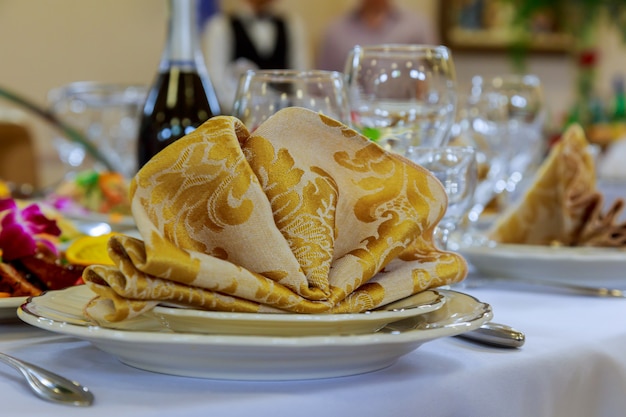 Empty glasses set with napkin in fine dining restaurant decorated