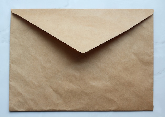 Photo an empty golden envelope on the table