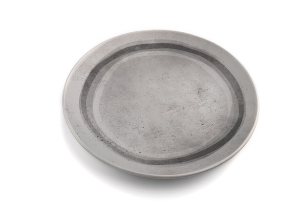 Empty gray ceramic plate isolated on white background. Side view, close up.