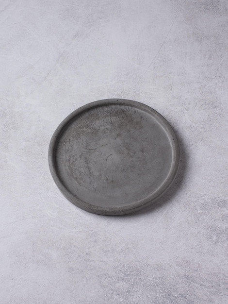 An empty gray concrete plate on a gray background Food background for menu recipe