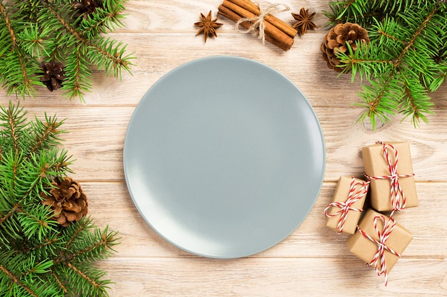 Empty gray matte plate on wooden  with christmas decoration, Round dish, New Year concept