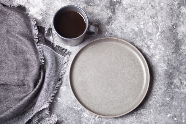 Empty gray plate and cup of coffee 