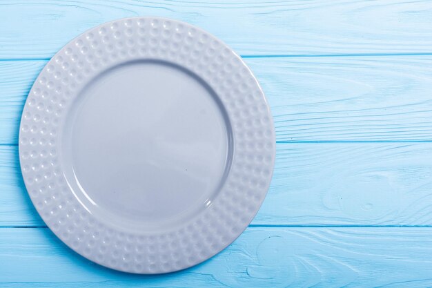 Empty gray plate on wooden table Top view background