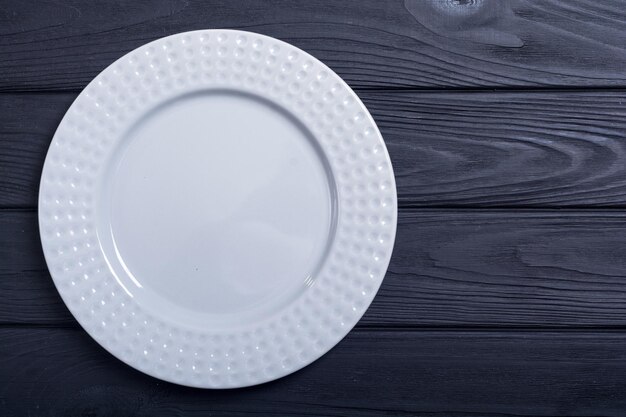 Empty gray plate on wooden table top view background