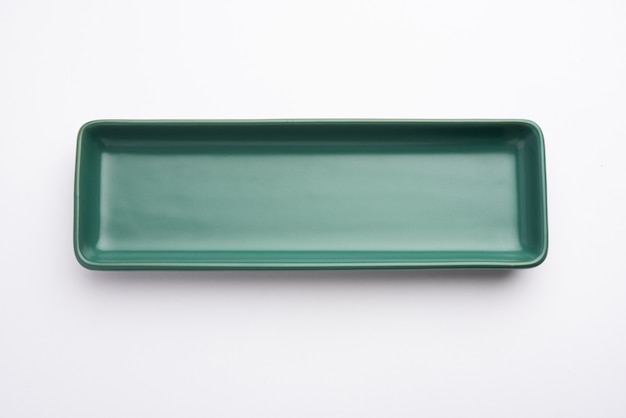 Empty green ceramic rectangular plate isolated on white surface