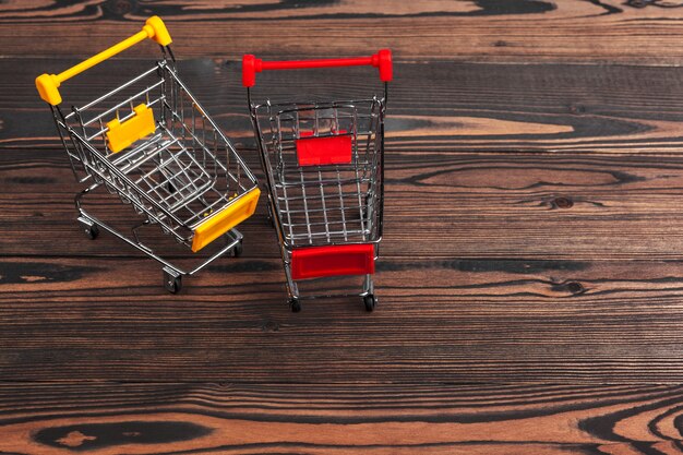 Empty grocery toy  shopping cart on a table