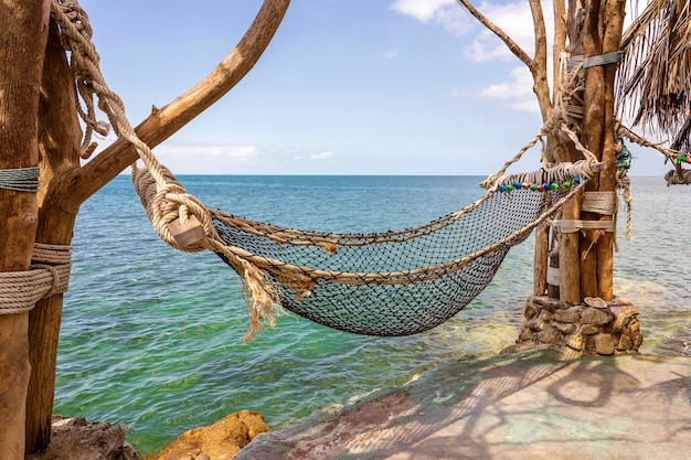 Empty hammock on beautiful tropical beach near blue sea water, Thailand, close up