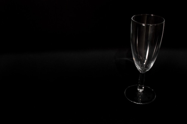 Photo empty сhampagne glass isolated on black background closeup photo of  tumbler