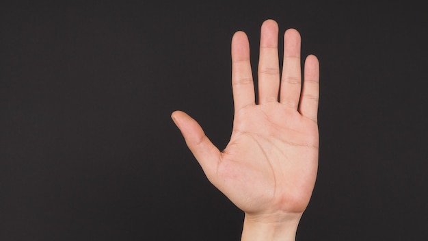 Empty hand palm on black background.