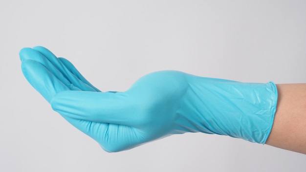 Empty hand wear blue medical glove on white background.