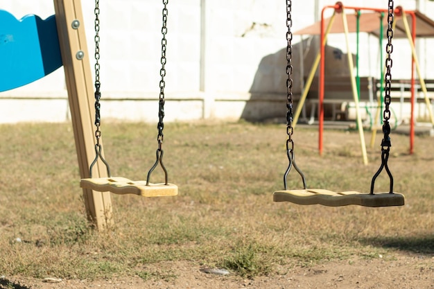 Premium Photo | Empty hanging swing in the playground new normal social ...