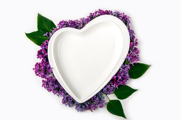 Empty heart shaped plate decorated with lilac flowers