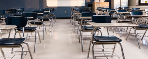 An empty high school classroom with students desks spaced out for social distancing