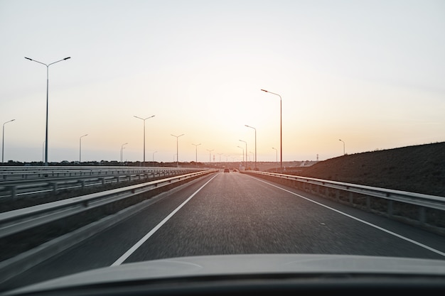 Empty highway at dawn, view from driver's perspective