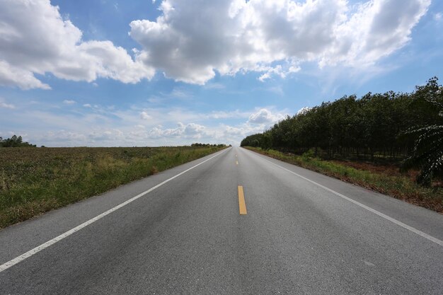 Empty highway road and countryside view on blue sky background