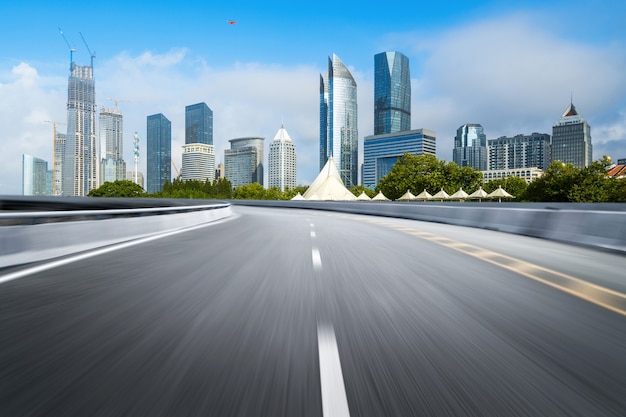 Empty highway with cityscape and skyline of qingdao, China.