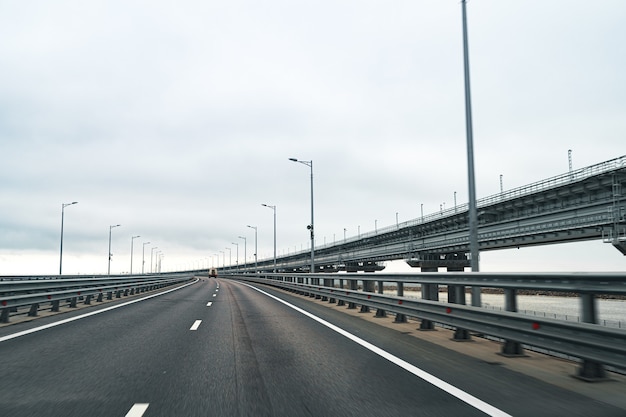 Empty highway with good asphalt road and cloudy sky