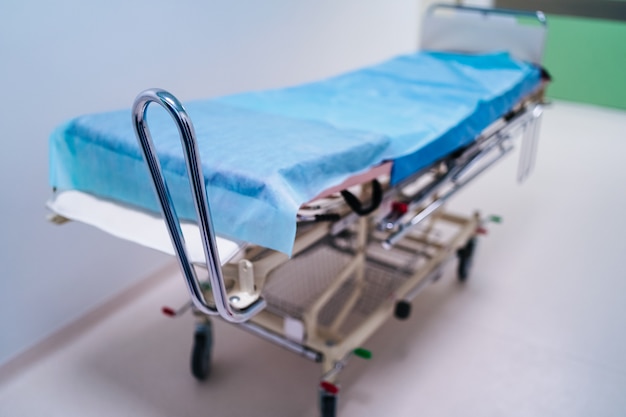 Empty hospital hallway with surgical transport equipment.