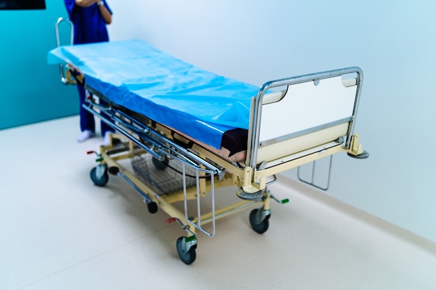 Empty hospital hallway with surgical transport equipment.