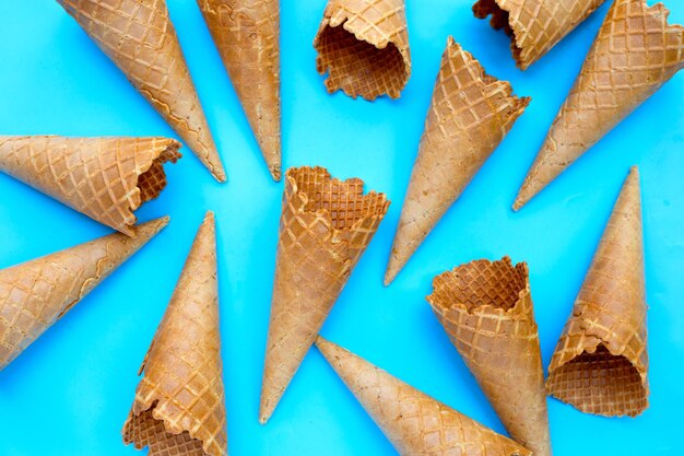 Empty ice cream cone on blue background