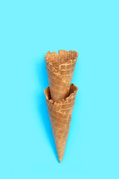 Пустой рожок мороженого на синем фоне
