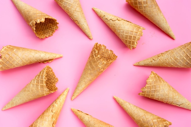 Empty ice cream cone on pink background